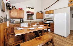 Enjoy cooking and dining in this well-equipped kitchen with a central island, microwave, stove, and refrigerator.
