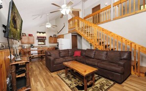 Relax in this inviting living area with a comfortable sofa and wooden coffee table.