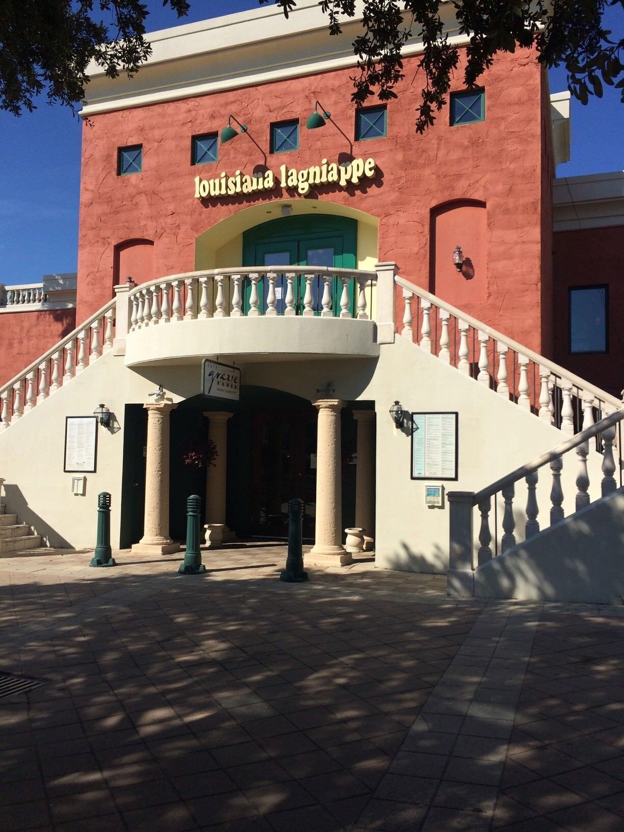 A building with a red facade and a sign reading "Louisiana lagniappe".