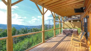 A wooden deck with a view of mountains, a fenced balcony, and a hot tub. - Theater, Games & Views! - Bigger Bear Views Lodge (Gatlinburg)