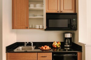 Microwave, coffee/tea maker, toaster, cleaning supplies