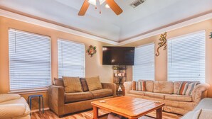 A living room with two sofas, a coffee table, and a TV. - Seas The Moment before it passes you by. (Freeport)