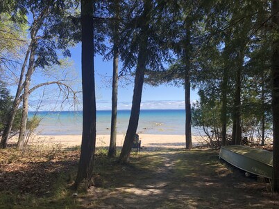 House on sandy beach in Omena. Budget friendly. Dog ok. Sunrise views.