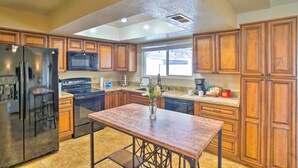 A kitchen with wooden cabinets, a stainless steel refrigerator, a microwave, and a stove. - Near Golf & Entertainment! Gilbert Family Getaway (Gilbert)