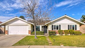 A two-story house with a garage, a front yard with a tree, and a clear blue sky. - Near Golf & Entertainment! Gilbert Family Getaway (Gilbert)