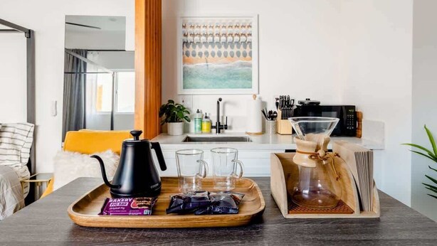A modern kitchen with a coffee maker, tea set, and a tray with food items. - Bright Modern Stay | Near LAX & Stadiums I Patio (Los Angeles)