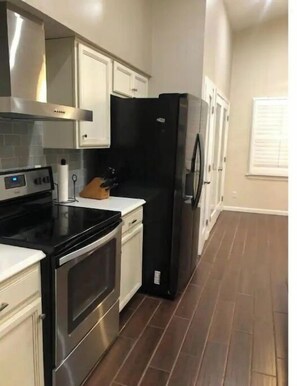 Enjoy cooking in this well-equipped kitchen with a stove, oven, and refrigerator.