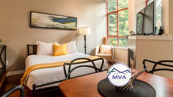 Relax in comfort with a large bed, dining area, and fireplace.