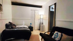 A bedroom with a bed, a chair, a radiator, and a door. - (M1) Enchanted Getaway ☀ 3-Mins Walk To River❣ (Carlsbad)