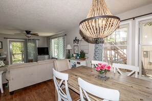 Relax in this open-plan living space with a large dining table and comfortable seating for meals and relaxation.