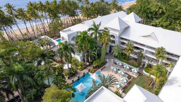 A resort with a pool, palm trees, and a beach view. - Belle Escapes 42 Alamanda Palm Cove (Palm Cove)