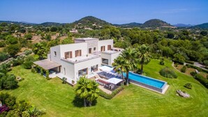 A modern two-story house with a swimming pool, surrounded by lush greenery and hills. - Villa "Son Sard" with Sea & Mountain View, Pool, A/C, Balcony, Garden & Terrace (Son Servera)