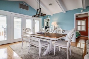 Enjoy meals in this cozy dining area with a wooden table and comfortable chairs.
