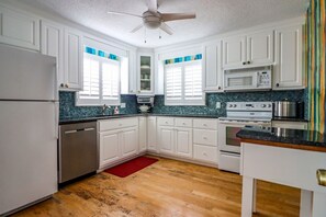 Enjoy cooking in this well-equipped kitchen with a refrigerator, oven, microwave, and dishwasher.
