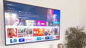 A flat-screen TV mounted on a wall displaying a streaming service interface with various shows and movies. - Piesendorf Pad Stunning Views Sleeps 8 (Piesendorf)