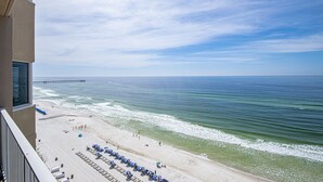 A beach view from a balcony with a pier in the distance. - Perfect Location, Perfect View
11th FL - 2 Bd, 2 Ba - Beachfront (Panama City Beach)