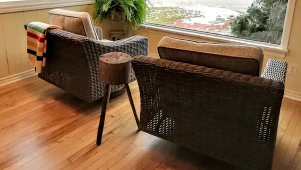 A room with wicker furniture, a view of the beach, and a plant. - BAYVIEW AND SUNRISE! 1 bedroom close to ski hills and Bruce County (MEAFORD)