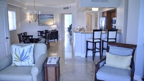 A spacious living room with a dining area, a kitchen, and a view of the dining area. - 10% weekly disc. 2BR-Ritz-Carlton Club St. Thomas-Instant Booking- Aug 1-8, 2026 (St Thomas)
