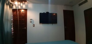 Cozy retreat with a single bed, flat-screen TV, and modern amenities.