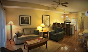 Relax in this inviting living space with a sofa, armchairs, and a dining area.