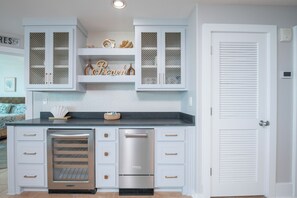 A kitchen with white cabinetry, a built-in oven, and a refrigerator. - Two Bedroom Condo with Views of Gulf, Bay, and Outdoor Pool Decks! (Orange Beach)