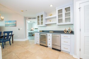 A kitchen with white cabinetry, a built-in oven, and a refrigerator. - Two Bedroom Condo with Views of Gulf, Bay, and Outdoor Pool Decks! (Orange Beach)