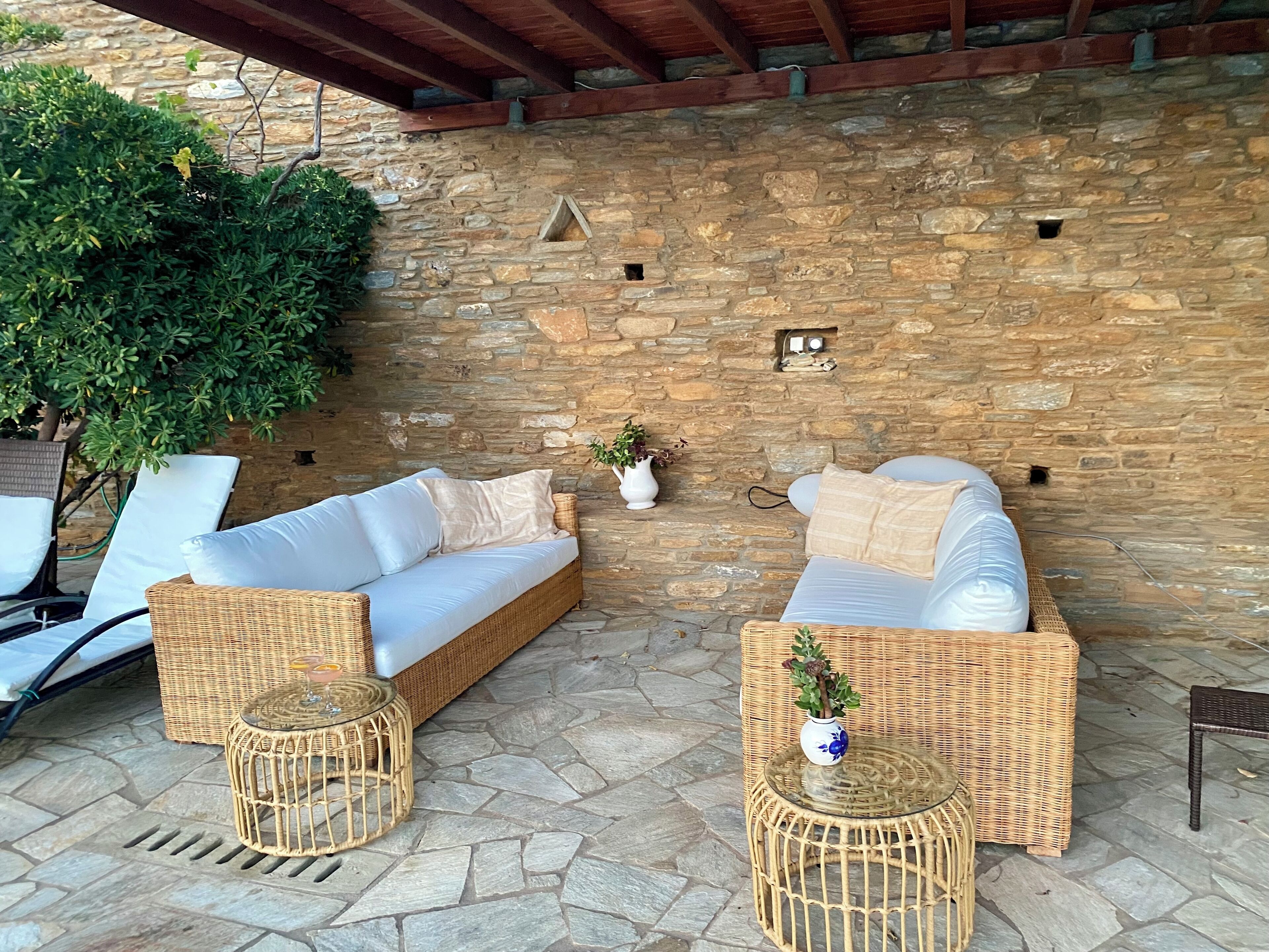 Eine Steinmauer mit integriertem Sitzplatz und einem Blumentopf.
