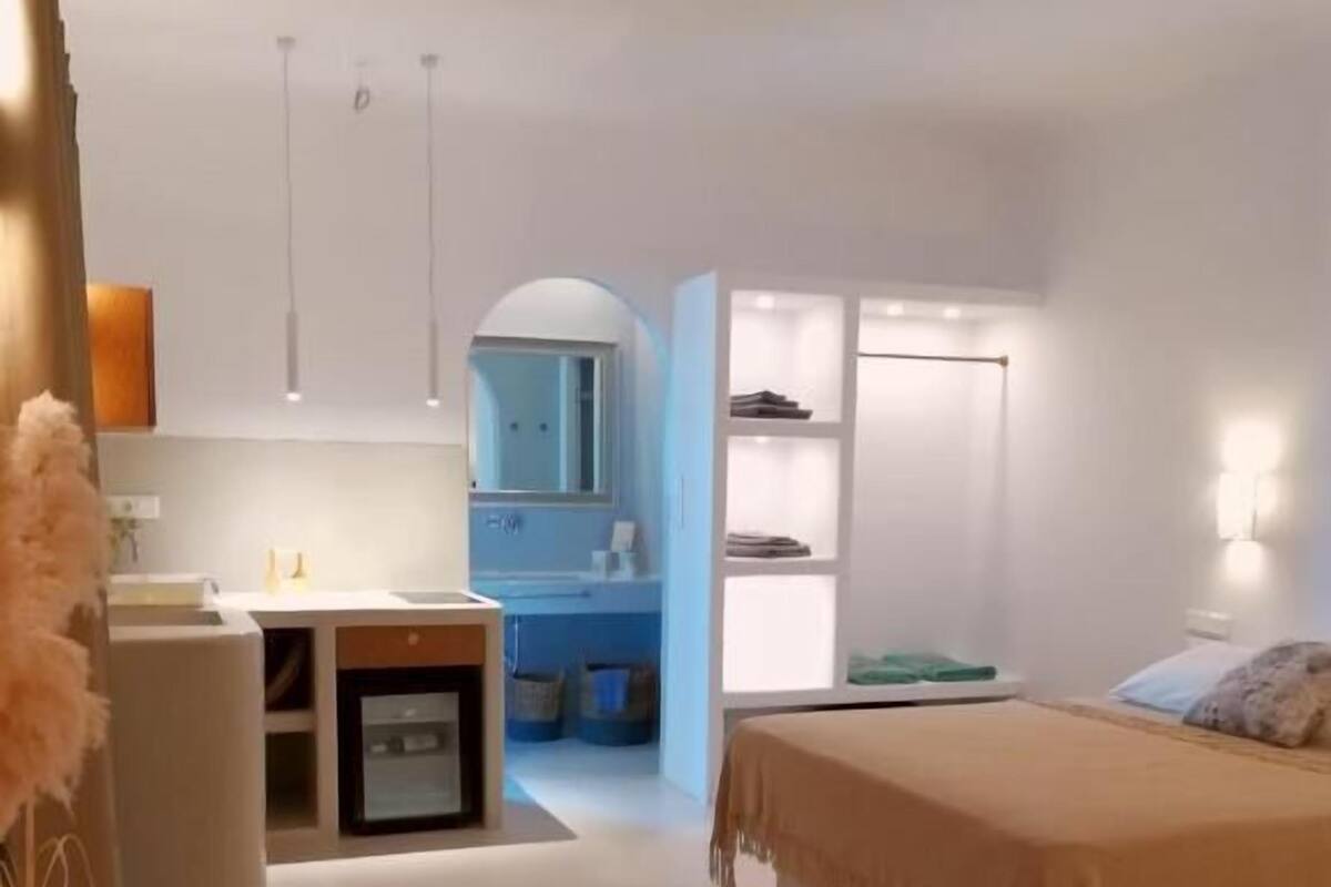 A modern bedroom with a bed, bedside table, and a built-in wardrobe.
