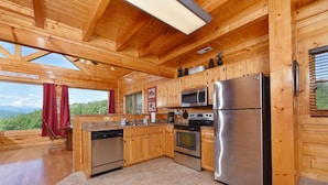 A wooden cabin kitchen with a large refrigerator, oven, microwave, and wooden cabinets. - Legacy Mtn Resort Cabin w/ Mtn View - 2 King Beds + 2 Sofa Beds HotTub & Jacuzzi (Sevierville)