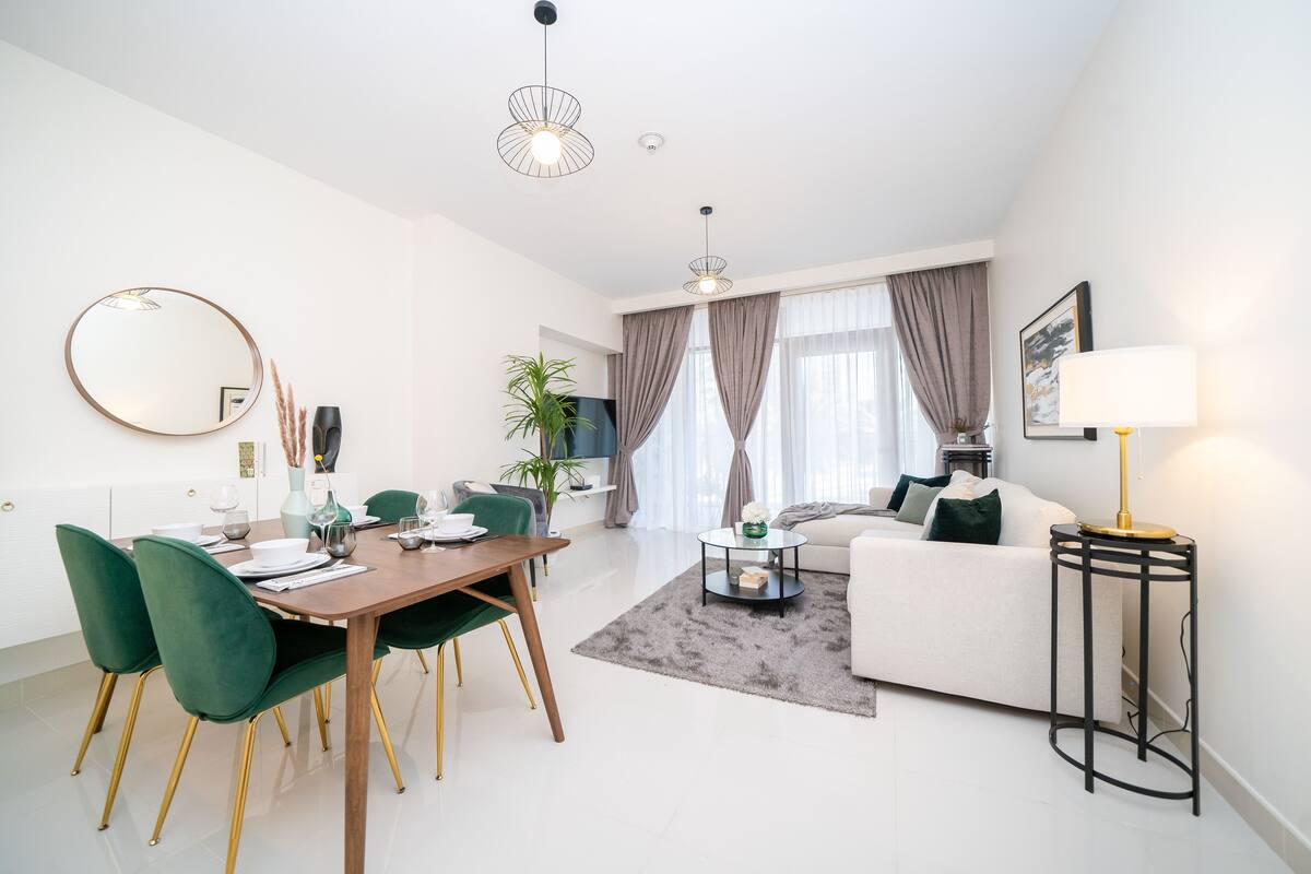 A modern living room with a dining area, a sofa, and a coffee table.