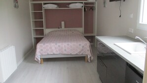 A small, compact room with a bunk bed, a single bed, a white sink, and a white countertop. - Le Pijolin (Saint-Justin)