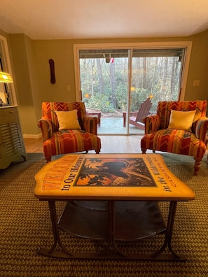 Relax in this inviting living room with a central coffee table and comfortable armchairs.