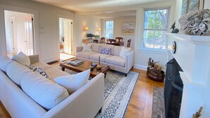 A living room with a sofa set, a coffee table, and a fireplace. - Stunning, Classic Renovated Greek Revival - few mins Walk to Main St & VH Ferry (Vineyard Haven)