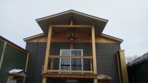 A two-story building with a balcony on the upper floor. - Downtown by the river (Hesperia)