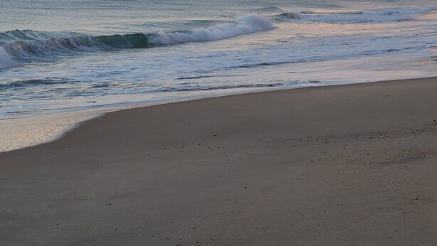 A beach with waves and a clear sky. - Shore Beats Work! (2040 Sq ft) (Kill Devil Hills)