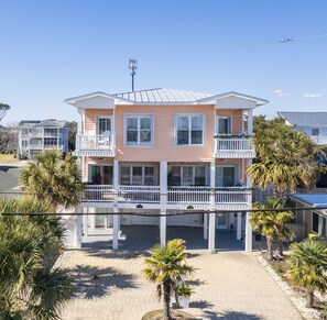 A two-story house with a balcony and a covered porch.
