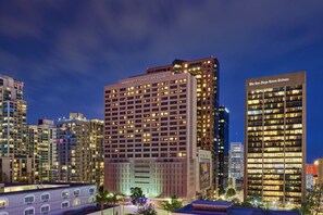 A multi-story building with a Marriott Vacation Club sign, surrounded by other high-rise buildings.