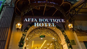 The entrance to the AFA Boutique Hotel with ornate architectural details and a sign above the entrance.