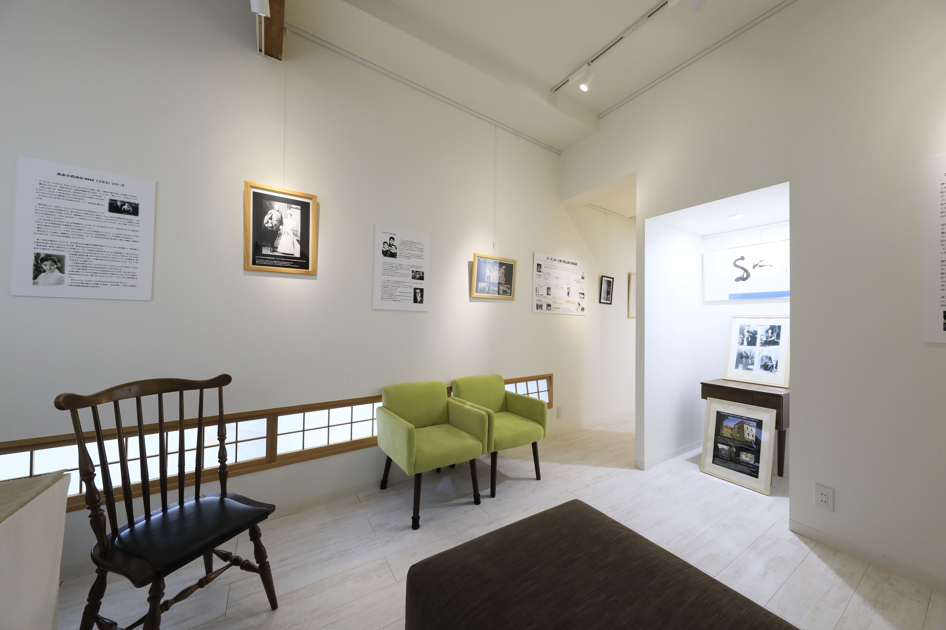 A gallery with framed photographs and informational panels on the walls.