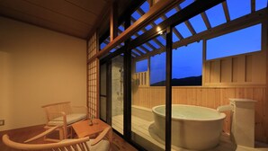 A wooden deck with a hot tub and seating area. - Yugarawa Fuga (Yugawara)