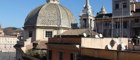 A building with a prominent dome and adjacent structures, including a bell tower.
