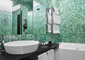 A bathroom with a large white sink, a glass-enclosed shower, and a bathtub. - LHP Suite Piazza di Spagna (Rome)