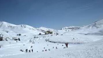 A snowy mountain landscape with a clear sky.