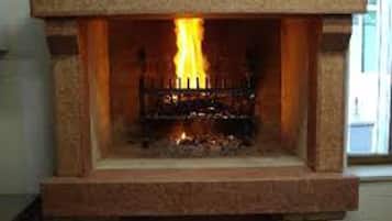 A fireplace with a fire burning inside.