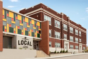A LEAVENWORTH LOCAL Hotel with a modern brick facade, large windows, and a welcoming entrance.