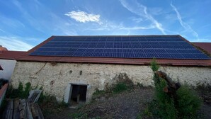 Un bâtiment dont le toit est équipé d’un ensemble de panneaux solaires.