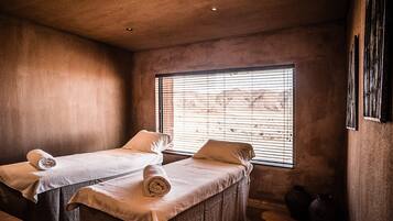 Two single beds, each with a neatly folded towel and pillow, await guests in this cozy retreat.