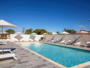 Seasonal outdoor pool, open 8:00 AM to 8:00 PM, pool umbrellas