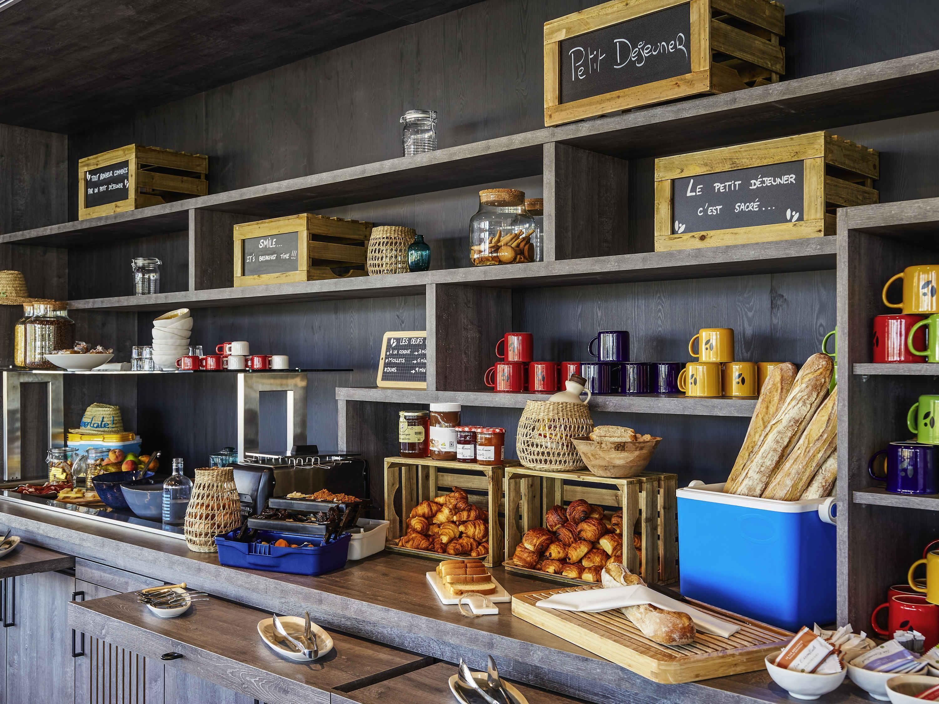 A breakfast buffet with various food items and utensils.
