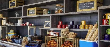 A breakfast buffet with various food items and utensils.